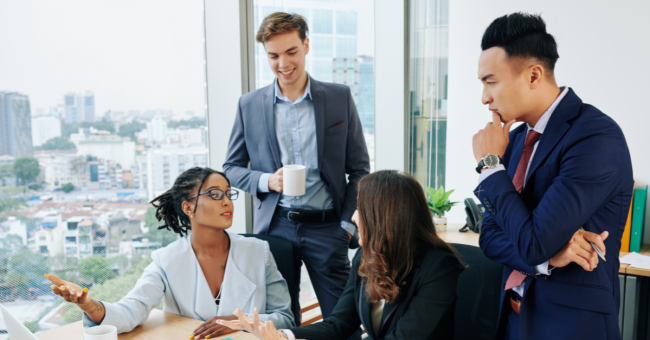 Business team engaged in storytelling session during digital transformation workshop, fostering connection and shared vision.