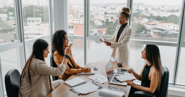 Woman sitting thoughtfully while engaging with Change Leadership concepts in a calm workspace.